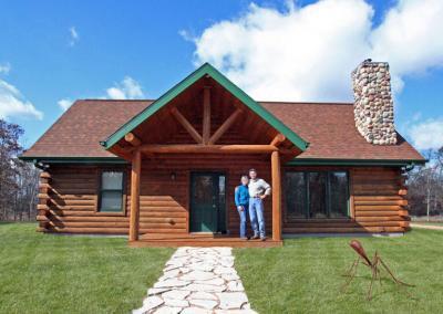 Exterior of log cabin with homeowners